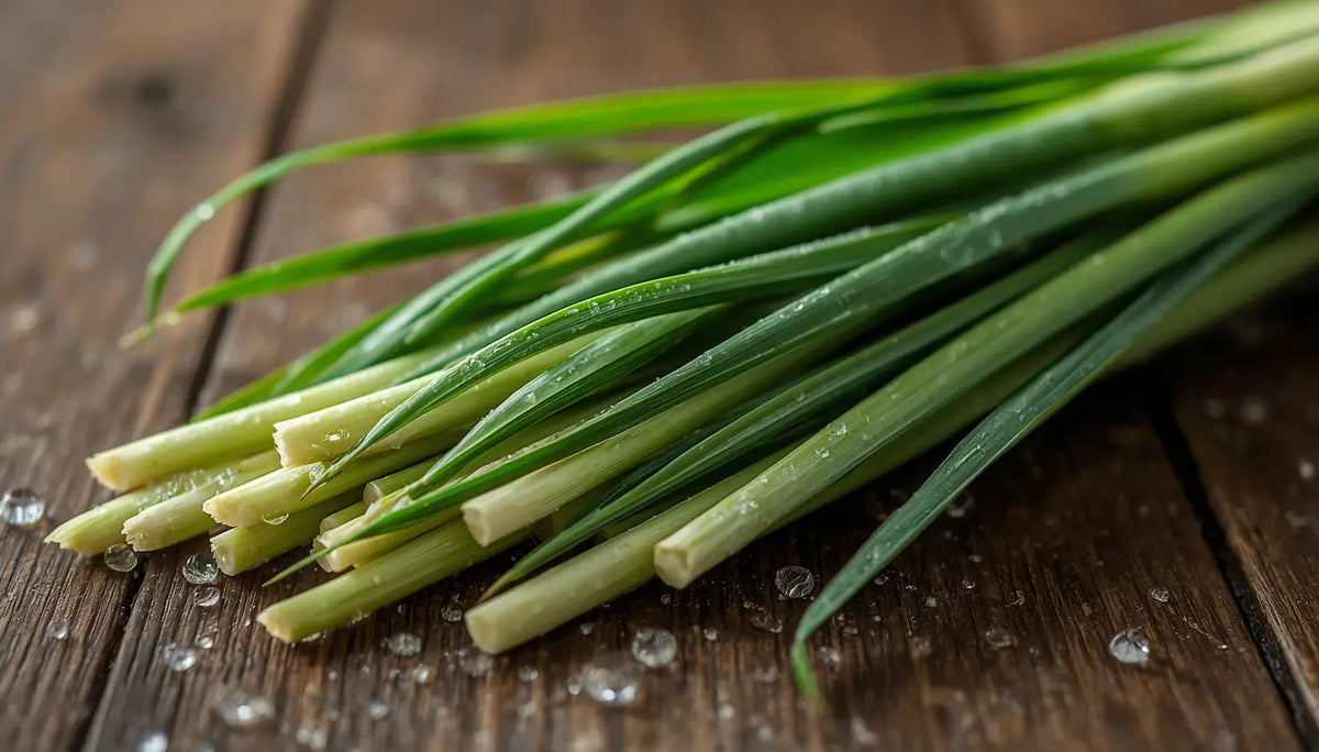 Freshly cut lemongrass on a wooden surface showcasing the advantages of lemongrass in culinary uses.
