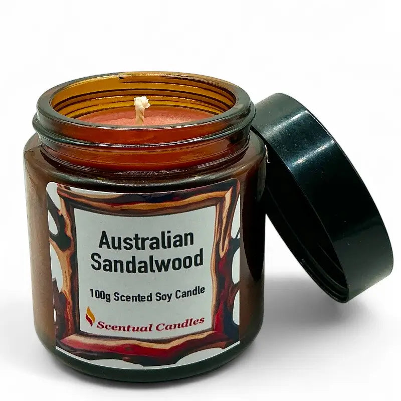 Australian Sandalwood Candle in amber glass jar with open lid, showcasing rich woody scent with 100g of scented soy wax.