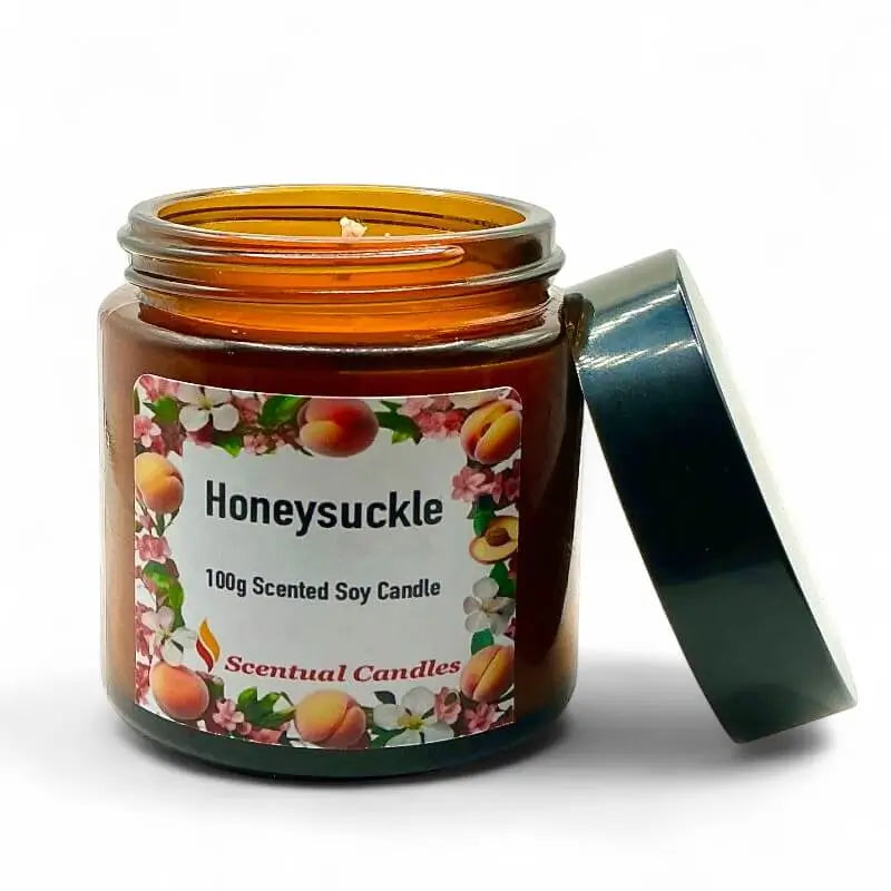Honeysuckle scented candle in an amber jar with a floral label on a white background