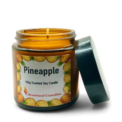 Pineapple Scented Tropical Soy Candle in amber jar with open lid, decorated with pineapple images.