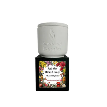 Australian Botanicals scented candle featuring floral and honey fragrances in a decorative holder.