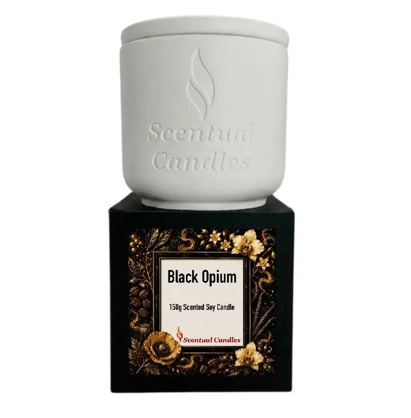 Black Opium Candle in a white ceramic jar on a decorative black box with floral design.