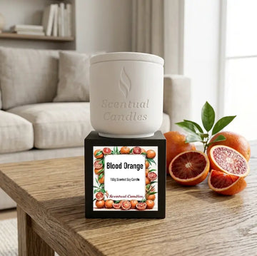 Blood Orange Candle in a white ceramic container with a black label featuring vibrant blood oranges.