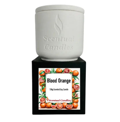 Blood Orange Candle in a white ceramic container with a black label featuring vibrant blood oranges.