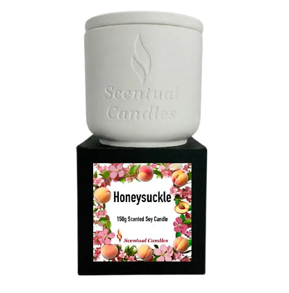 Honeysuckle Scented Candle in a white ceramic container, featuring floral design and label, perfect for home fragrance.