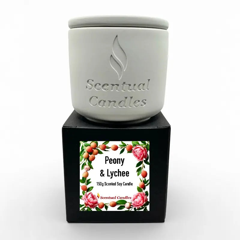 Lychee Scented Candle with Peony and Raspberries in a decorative jar on a black box