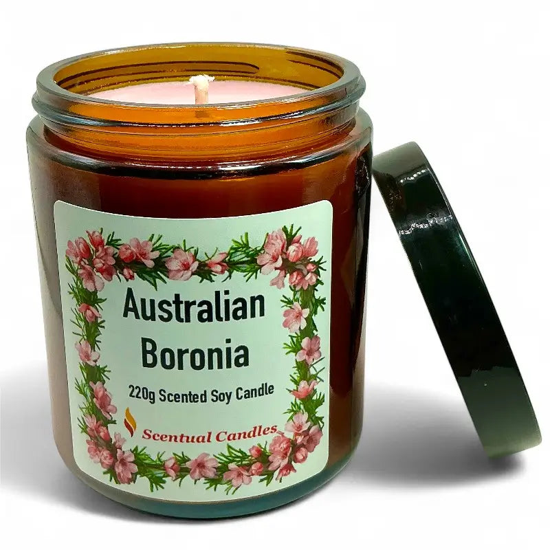 Scented soy candle in an amber jar with a floral label on a white background