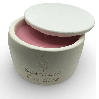 Scented soy candle in a white ceramic jar on white background