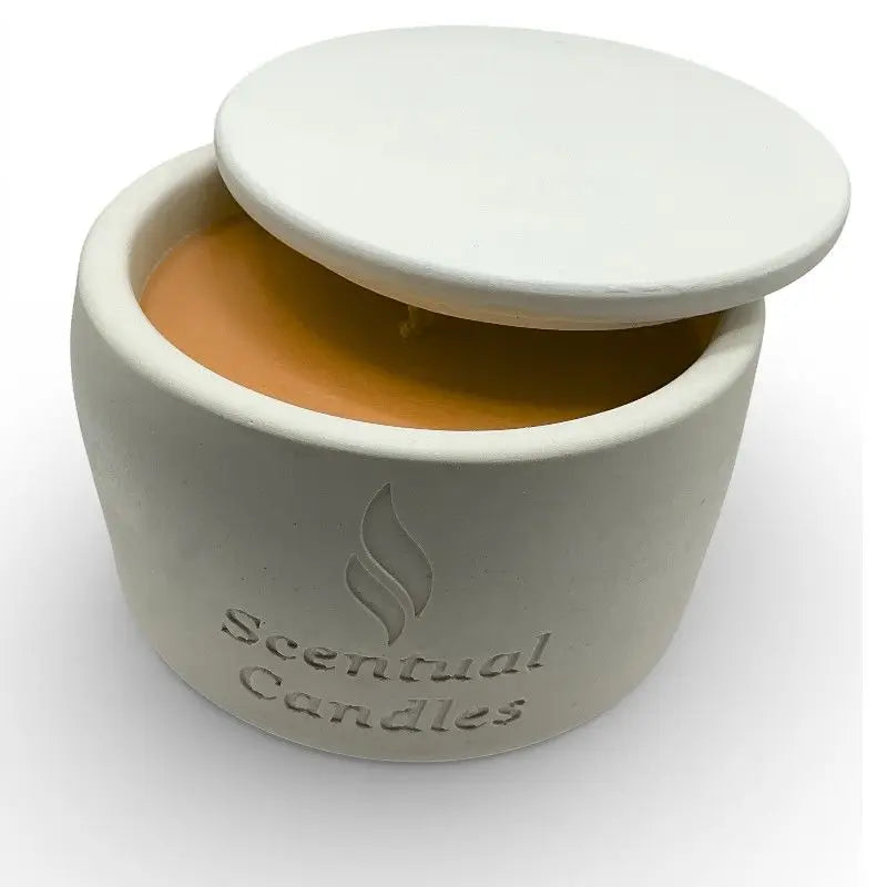 Citrus candle  in a ceramic jar with a lid on a white background, branded 'Scentual Candles'.