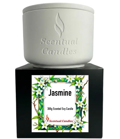 Jasmine Candle in a white ceramic container on a black box, featuring floral artwork and branding from Scentual Candles.