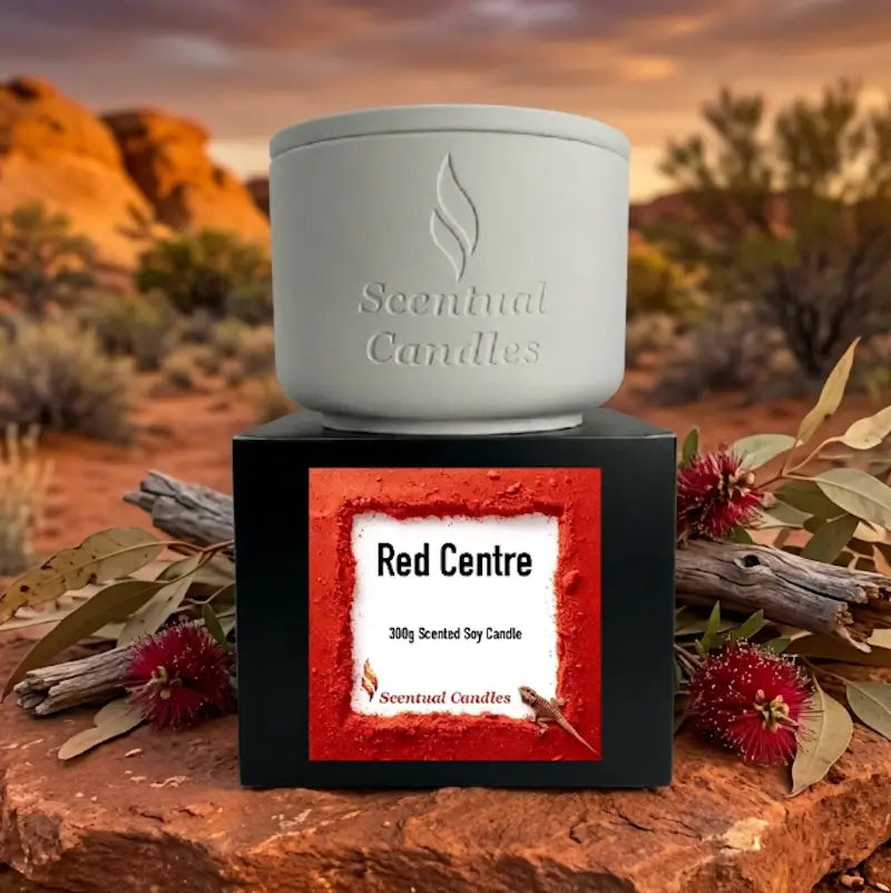 Spicy Vanilla and Buddhawood 'Red Centre' candle in a white holder with black packaging, part of the Australian Scents Collection.