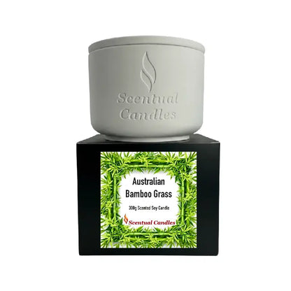 Bamboo Grass scented soy candle in a white container with Australian Bamboo Grass label, creating a fresh ambiance.