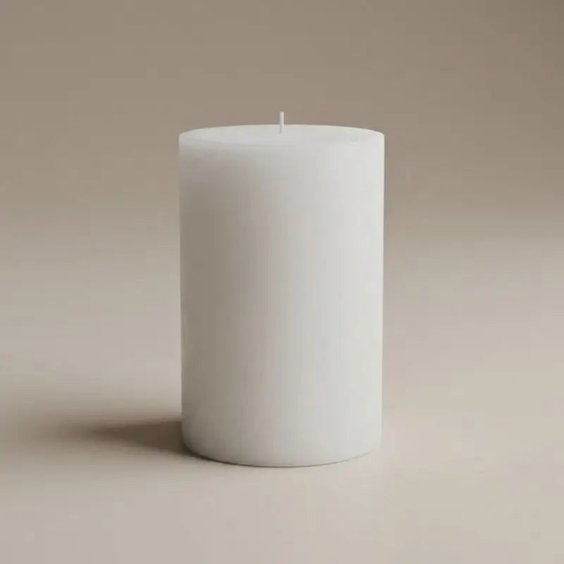 Vanilla Patchouli and Sandalwood pillar candle in white, perfect for a calming and elegant ambiance.