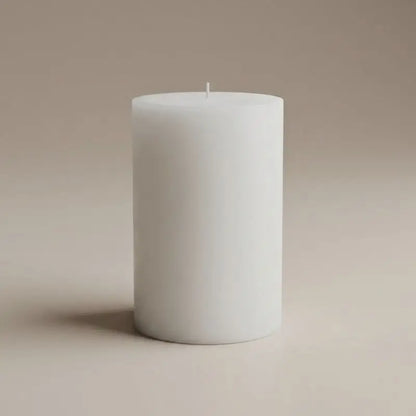 Vanilla Patchouli and Sandalwood pillar candle in white, perfect for a calming and elegant ambiance.