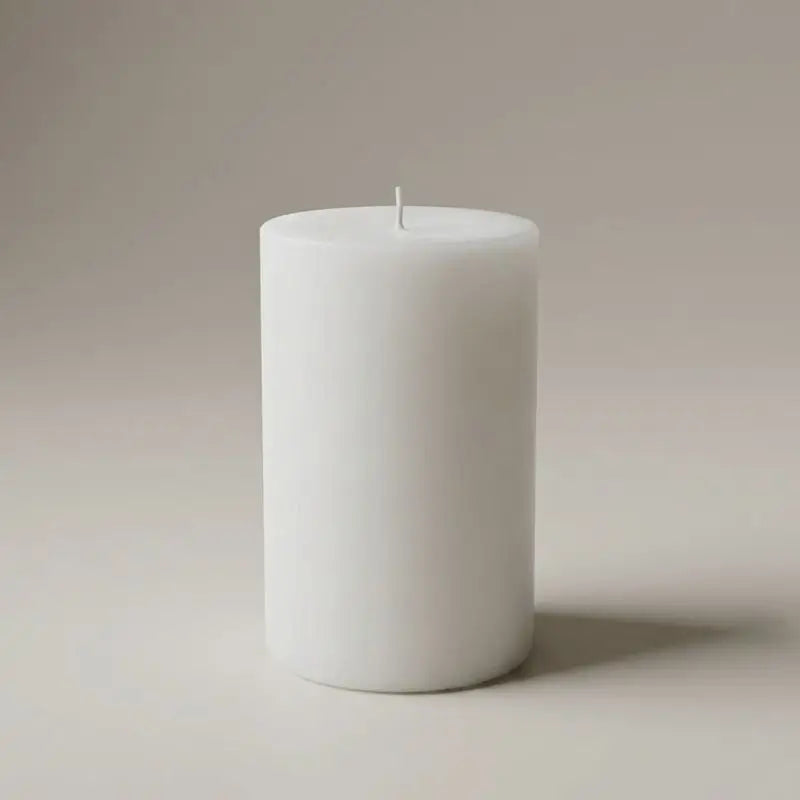Vanilla Patchouli and Sandalwood white pillar candle, elegant and calming décor piece.