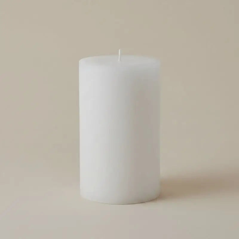 White Pillar Candles on a neutral background, showcasing a simple and elegant design.