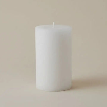 White Pillar Candles on a neutral background, showcasing a simple and elegant design.