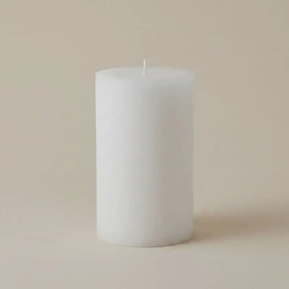 White Pillar Candles on a neutral background, showcasing a simple and elegant design.