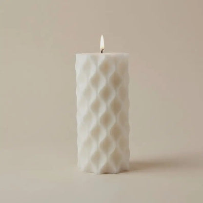 White Pillar Candles featuring a textured design and warm flame, perfect for enhancing ambiance.