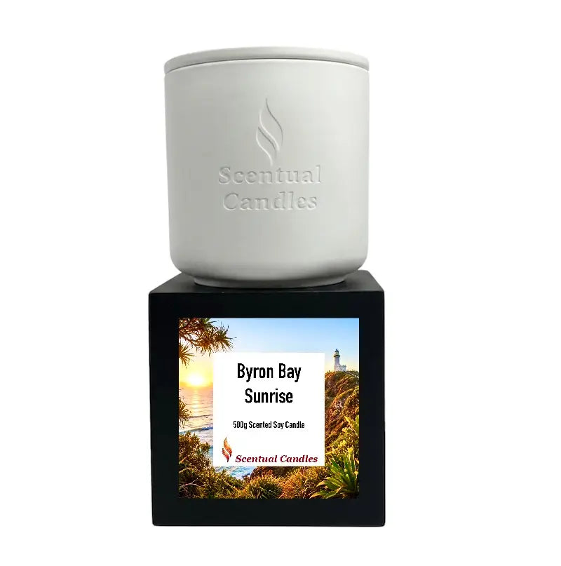 Byron Bay Scented Soy Candle displayed in white container with black label featuring Byron Bay Sunrise.