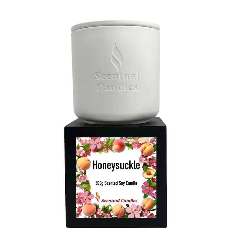 Honeysuckle Scented Candle in a white jar on a black base, featuring floral and fruity design elements.