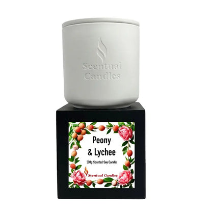 Lychee Scented Candle displayed with Peony and Raspberries fragrance label on a stylish stand.