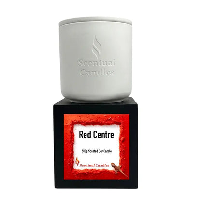 Spicy Vanilla and Buddhawood 'Red Centre' Candle in a white container on a black base.