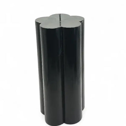 Black vanilla flower shaped candle on a white background