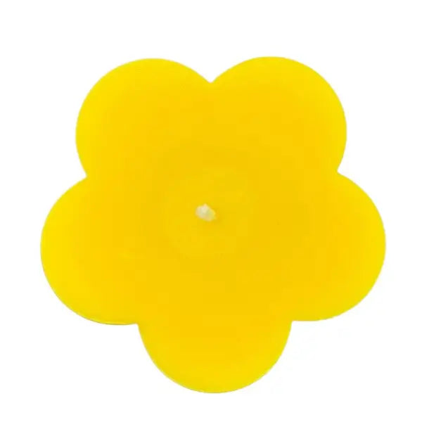 Yellow flower-shaped candle on a white background