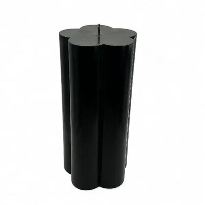 Black vanilla flower shaped candle on a white background