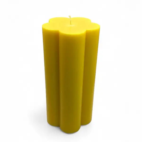 Yellow candle with a unique shape on a white background