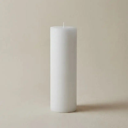 White pillar candle for relaxing ambiance and aroma with Vanilla Patchouli and Sandalwood.