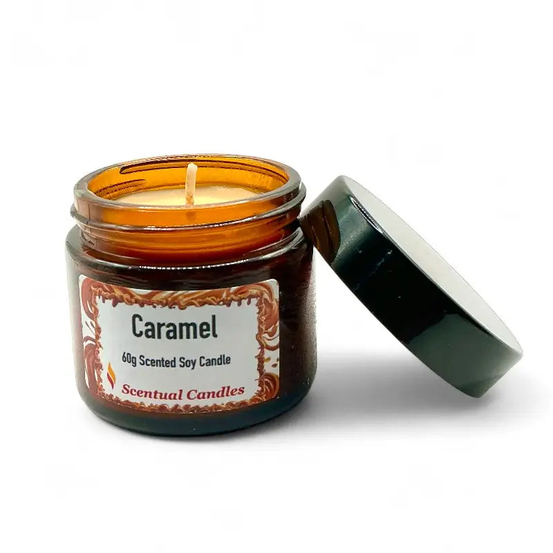 Caramel candle in an amber glass jar with a white label on a white background