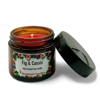 Fig and Cassis scented soy candle in a glass jar with opened lid, featuring a label with fig and cassis fruits design.