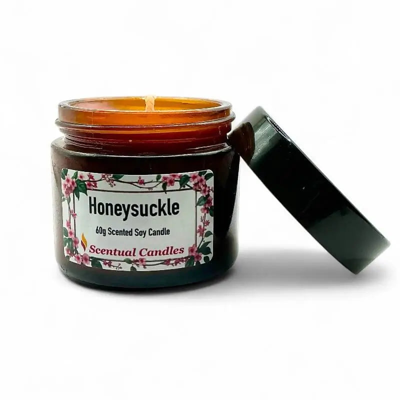 Honeysuckle scented candle in a jar with a floral label on a white background