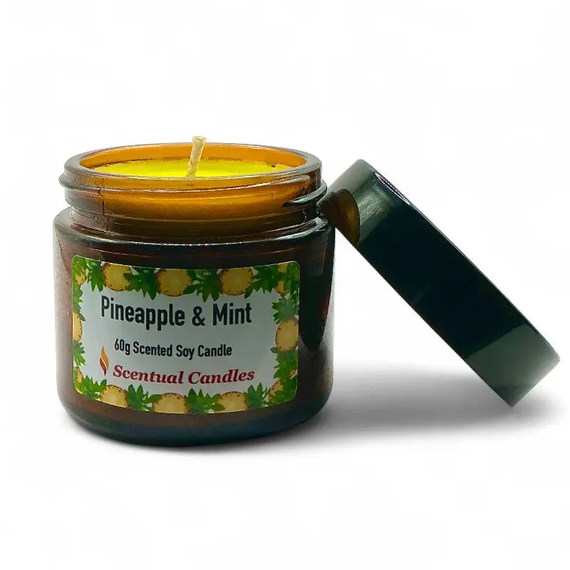 Scented candle in an amber jar labeled 'Pineapple and Mint' on a white background
