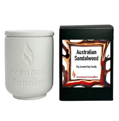 Australian Sandalwood Candle in a white ceramic jar next to its packaging, showcasing its rich and woody scent.
