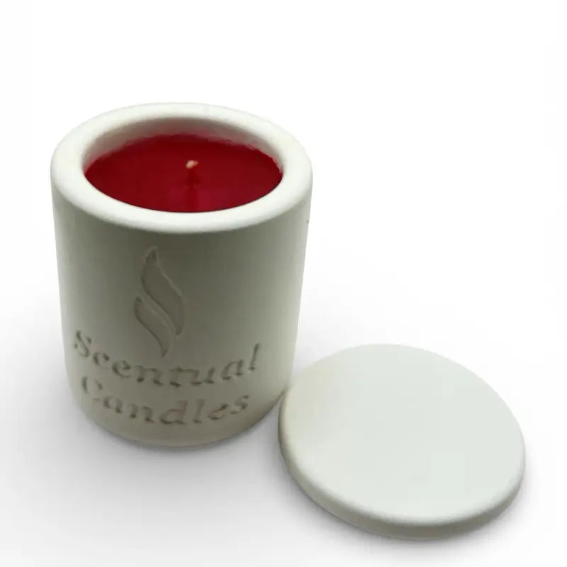 Vanilla and Cinnamon candle in a ceramic jar with a red candle inside on a white background