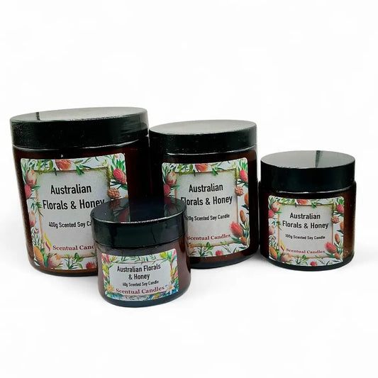 Four jars of Australian Florals & Honey candles on a white background