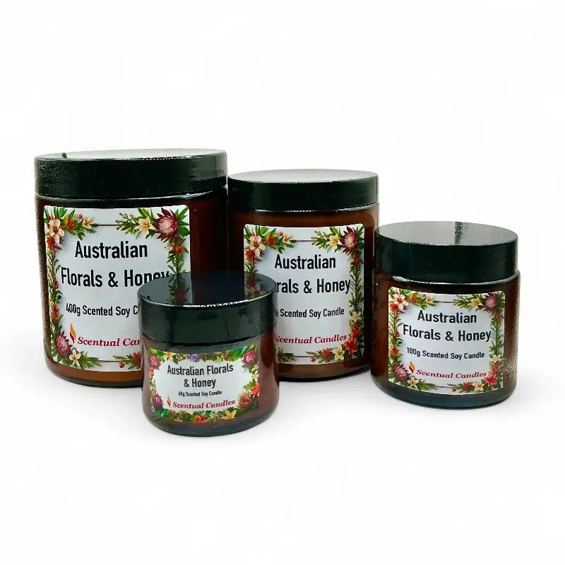Four jars of 'Australian Florals & Honey' scented candles on a white background