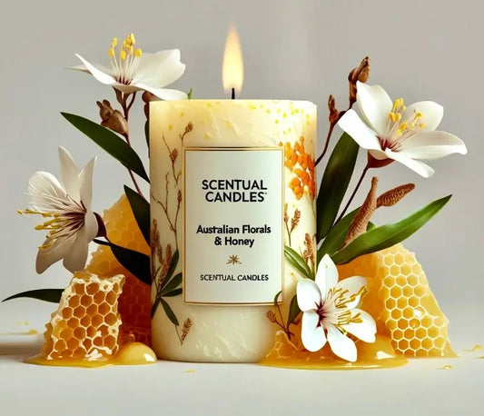 Scentual candles with Australian Florals & Honey theme, surrounded by flowers and honeycomb.