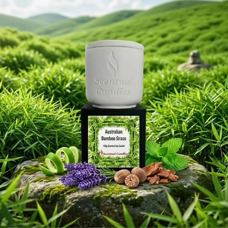 A Bamboo Grass scented soy candle surrounded by bamboo plants, showcasing its natural, refreshing fragrance and design.