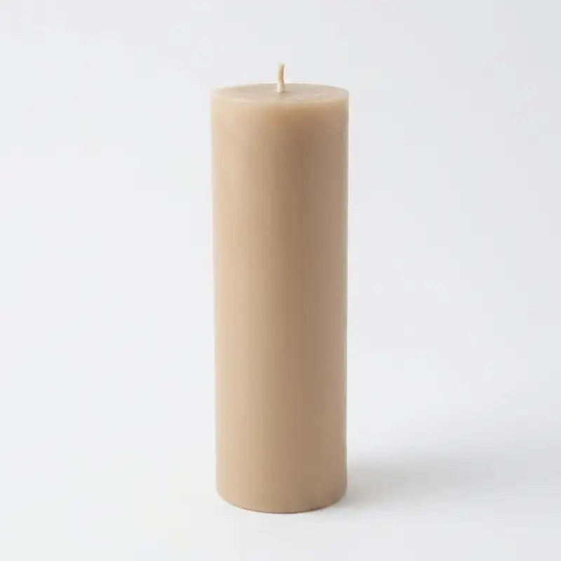 Big Candle in beige color, oversized pillar design, on a white background