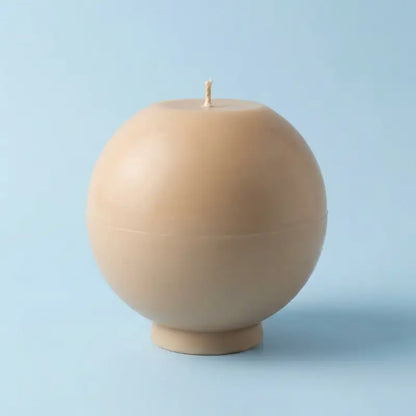 Round Candle in a  beige hue, showcasing its sculptural design and oversized shape.