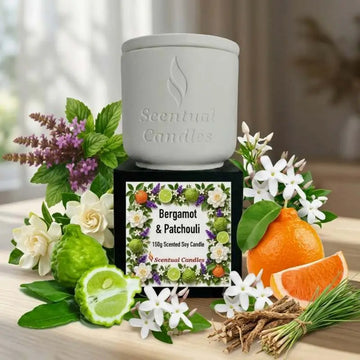 Bergamot Candle with Patchouli displayed with fresh flowers and citrus fruits, showcasing its natural ingredients and design.