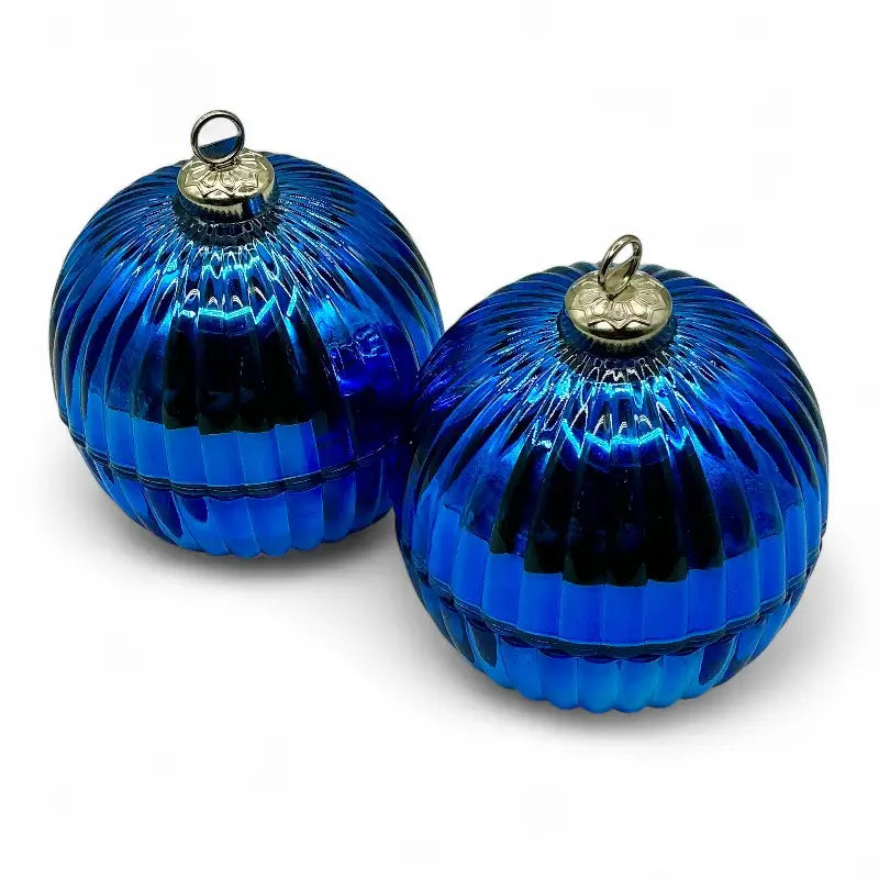 Blue Glass Bauble Christmas Scented Candles in ribbed jars with gold tops, perfect for festive decor and ambiance.