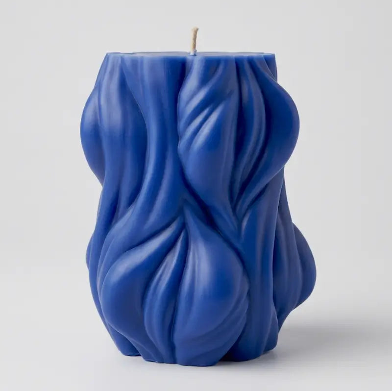 Decorative Candle in a unique blue design with textured waves, perfect for home decor and ambiance enhancement.