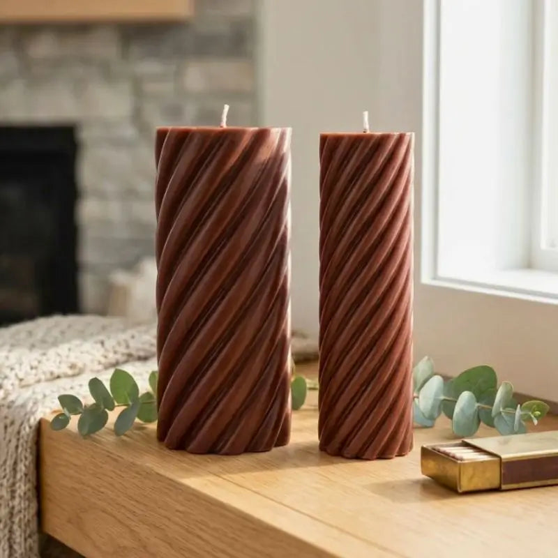 Pillar Candle Set featuring two spiral columns, one large and one slim, showcasing their decorative design on a wooden table.