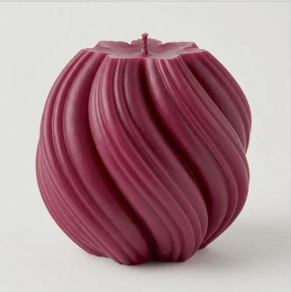 Extra large Ball Candle in deep burgundy with sculptural swirls, ideal as a decorative home accent.