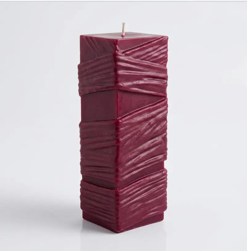 Custom Candle - Large Sculptural Design in deep burgundy color with a textured surface.
